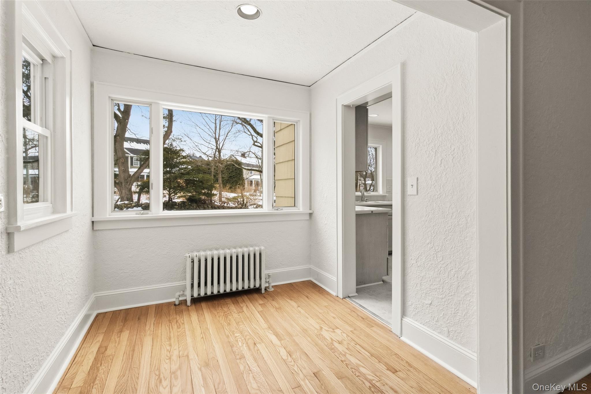 23 Garretson Road White Plains, NY 10604 - Photo 8 of 33 a view of an empty room with a window and wooden floor