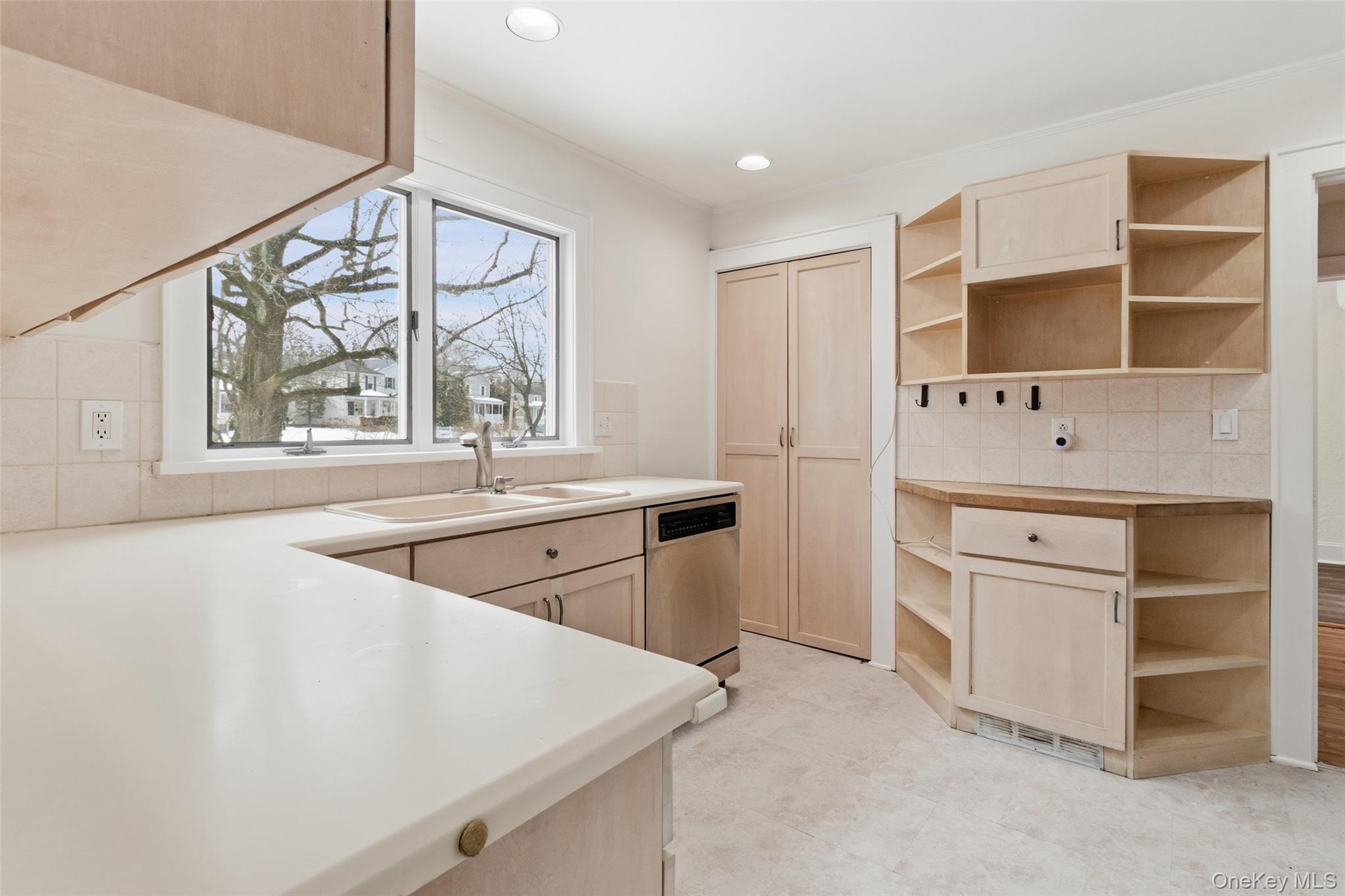 23 Garretson Road White Plains, NY 10604 - Photo 9 of 33 a kitchen with white cabinets and window