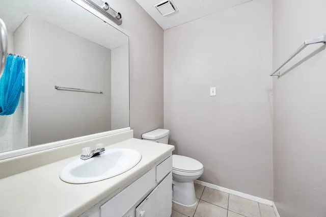 a bathroom with a sink toilet and mirror