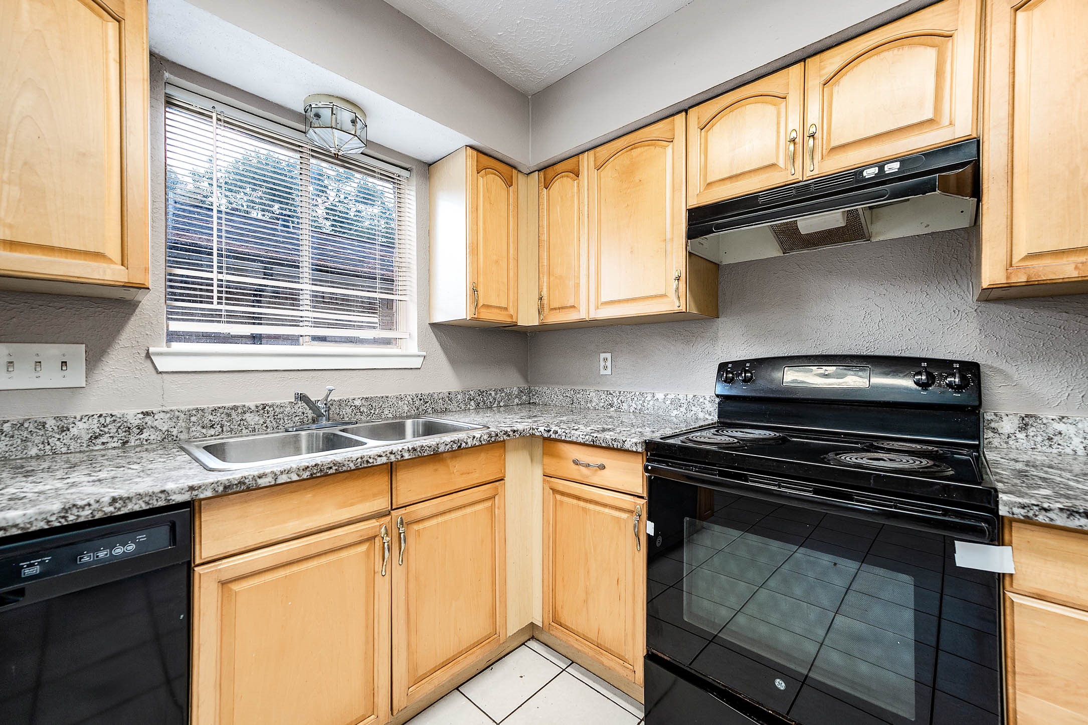 4918 Quailgate Drive Spring, TX 77373 - Photo 8 of 17 a kitchen with granite countertop a sink stainless steel appliances and cabinets