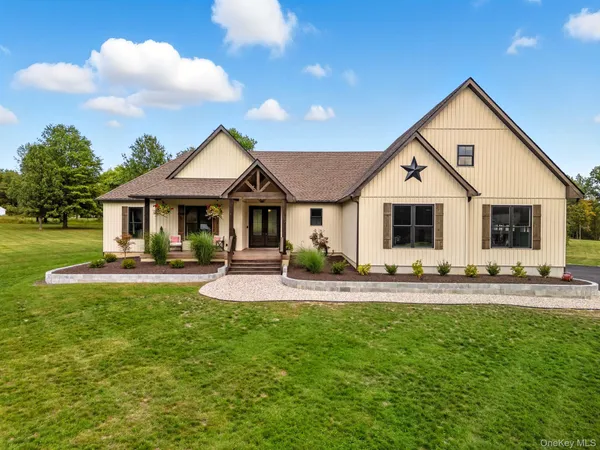 a front view of a house with patio and garden