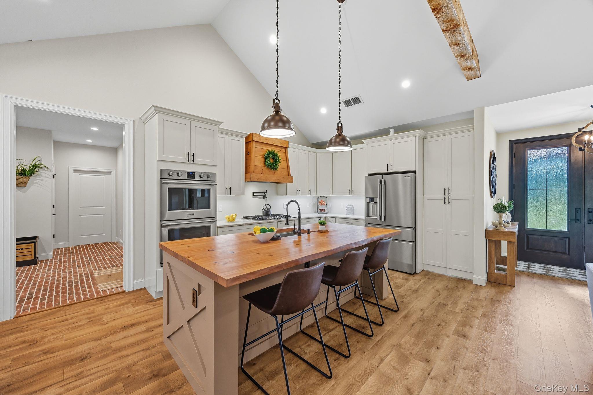 11 Knolls Road Wallkill, NY 12589 - Photo 36 of 48 a kitchen with stainless steel appliances kitchen island granite countertop a table chairs sink and cabinets