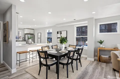 a view of a dining room with furniture and wooden floor