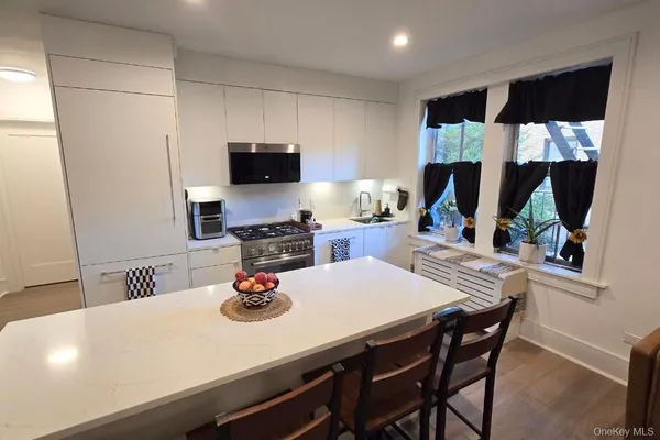 a kitchen with a table chairs a stove and a refrigerator