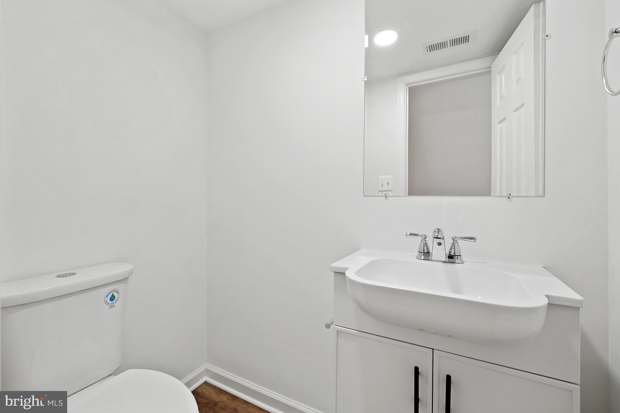 3731 Falls Road Baltimore, MD 21211 - Photo 26 of 30 a bathroom with a sink mirror and toilet
