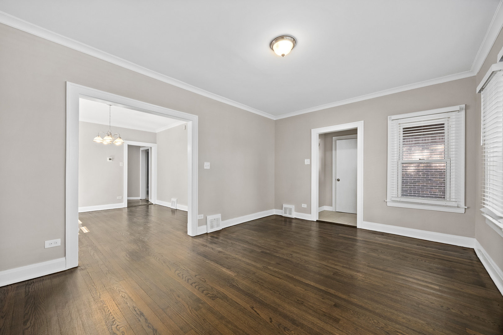 6535 26th Place Berwyn, IL 60402 - Photo 7 of 26 an empty room with wooden floor and windows