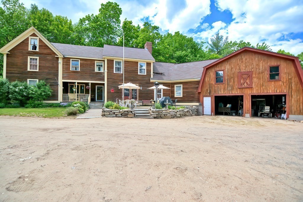 244 Davis Road Ashby, MA 01431 - Photo 1 of 35 a front view of a house with a yard and garage