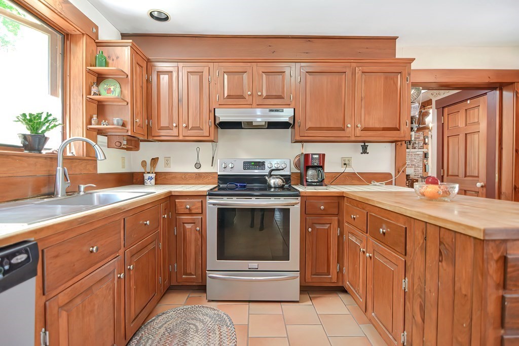 244 Davis Road Ashby, MA 01431 - Photo 13 of 35 a kitchen with stainless steel appliances granite countertop a sink stove and cabinets