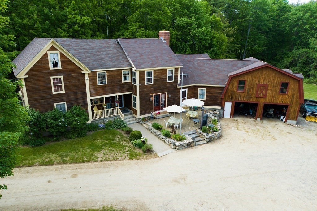 244 Davis Road Ashby, MA 01431 - Photo 2 of 35 a front view of a house with a yard and garage