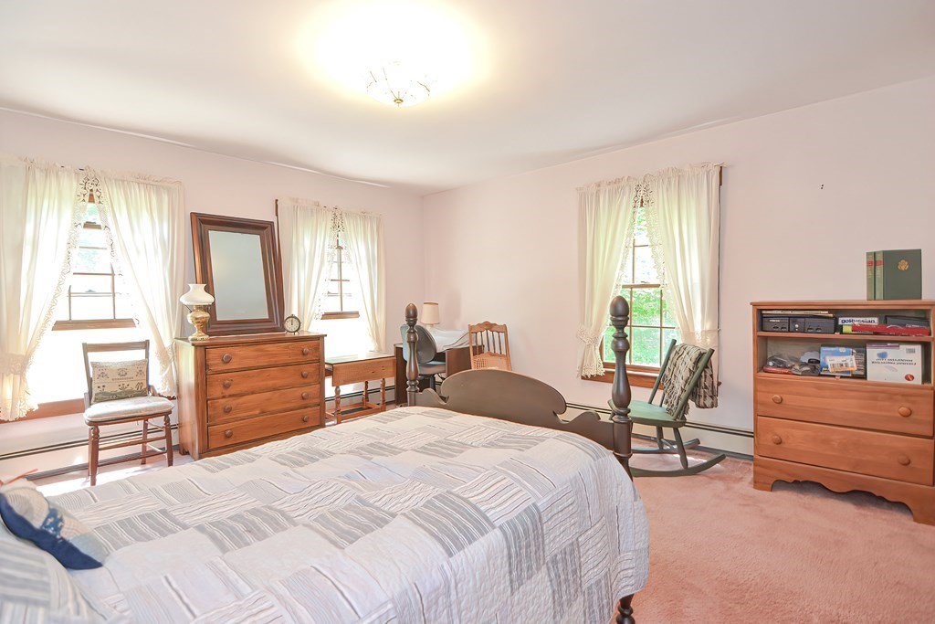 244 Davis Road Ashby, MA 01431 - Photo 22 of 35 a bedroom with a bed and furniture with mirror