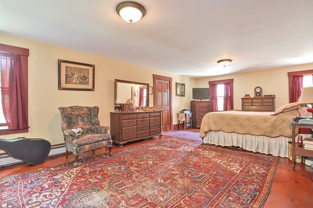 244 Davis Road Ashby, MA 01431 - Photo 25 of 35 a bedroom with a bed dresser and wooden floor