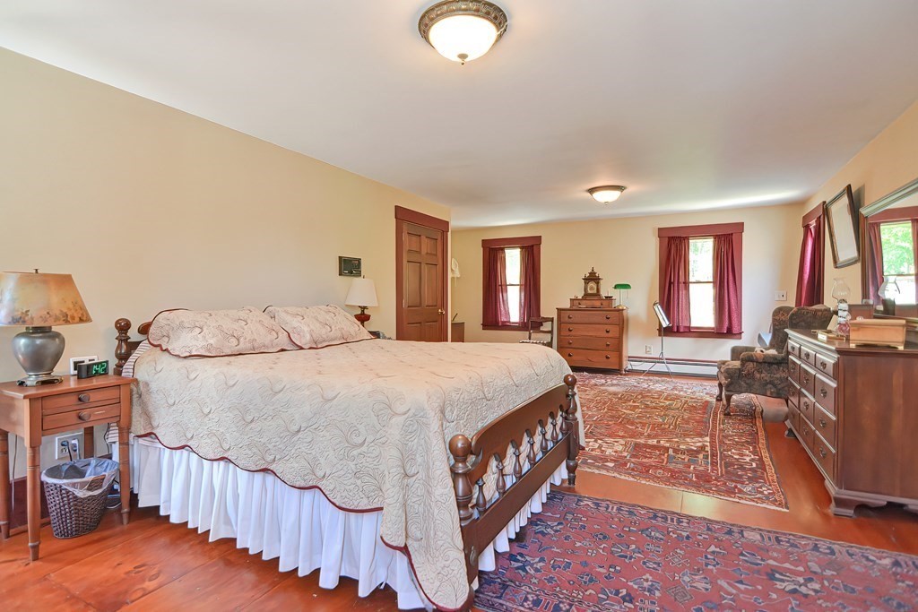 244 Davis Road Ashby, MA 01431 - Photo 26 of 35 a spacious bedroom with a bed a window and dresser
