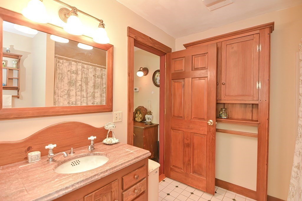 244 Davis Road Ashby, MA 01431 - Photo 27 of 35 a bathroom with a granite countertop sink a mirror and a shower