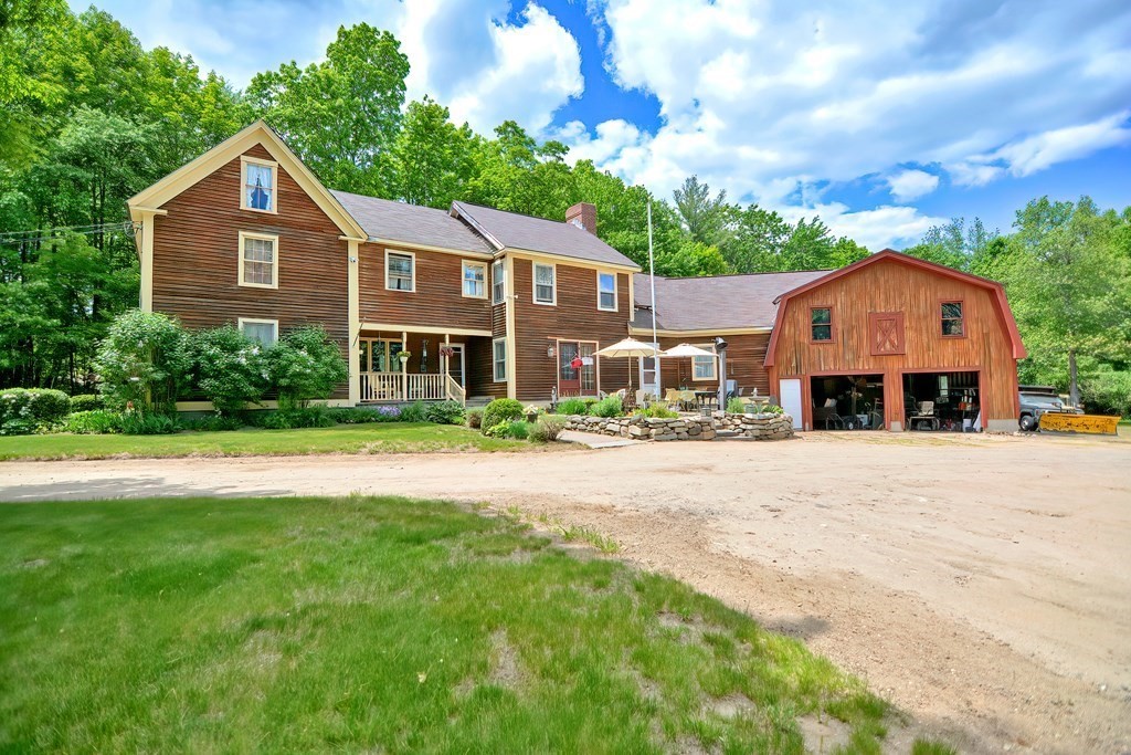 244 Davis Road Ashby, MA 01431 - Photo 28 of 35 a front view of a house with a yard and garage