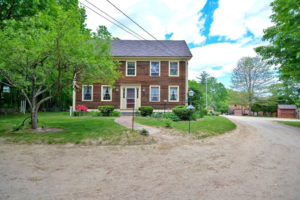 244 Davis Road Ashby, MA 01431 - Photo 30 of 35 a front view of a house with a yard and trees