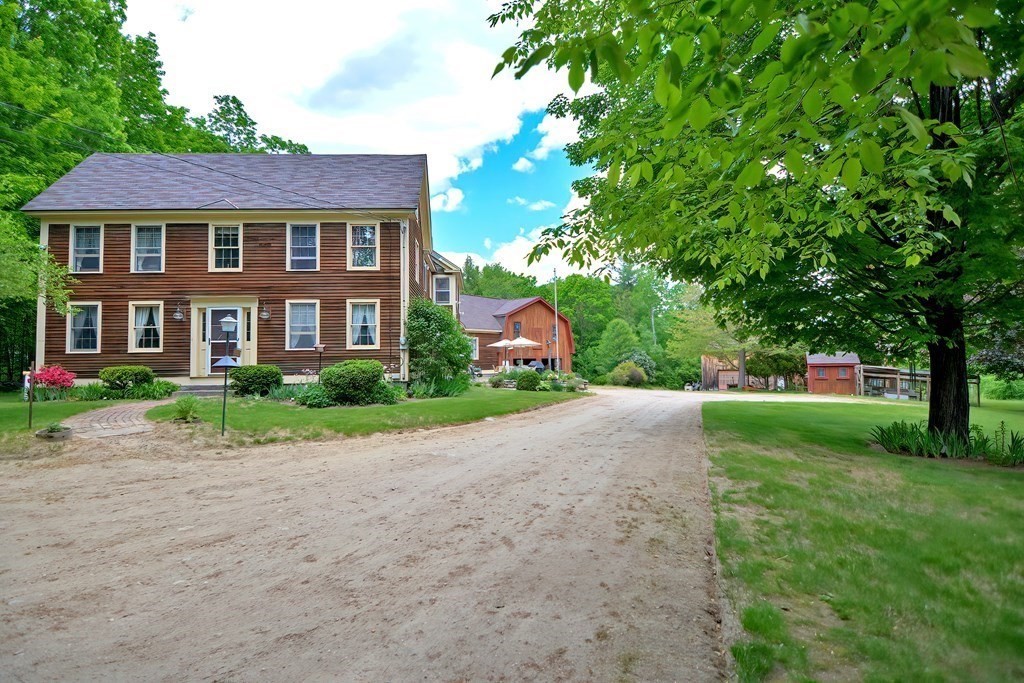 244 Davis Road Ashby, MA 01431 - Photo 31 of 35 a front view of a house with a yard and a garage