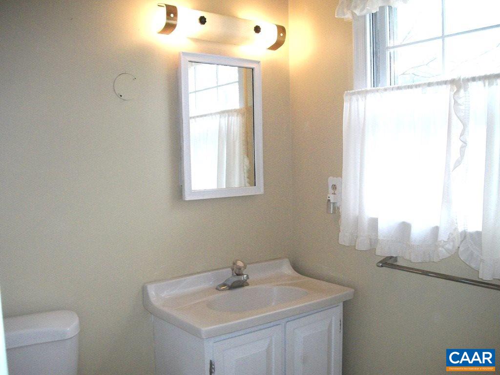 5584 Laurel Ridge Road Charlottesville, VA 22911 - Photo 18 of 28 a bathroom with a sink mirror and a window