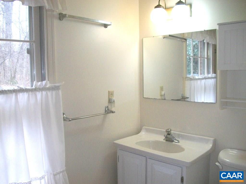 5584 Laurel Ridge Road Charlottesville, VA 22911 - Photo 21 of 28 a bathroom with a sink and a mirror
