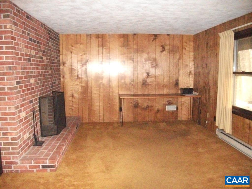 5584 Laurel Ridge Road Charlottesville, VA 22911 - Photo 23 of 28 a view of an empty room with a fireplace