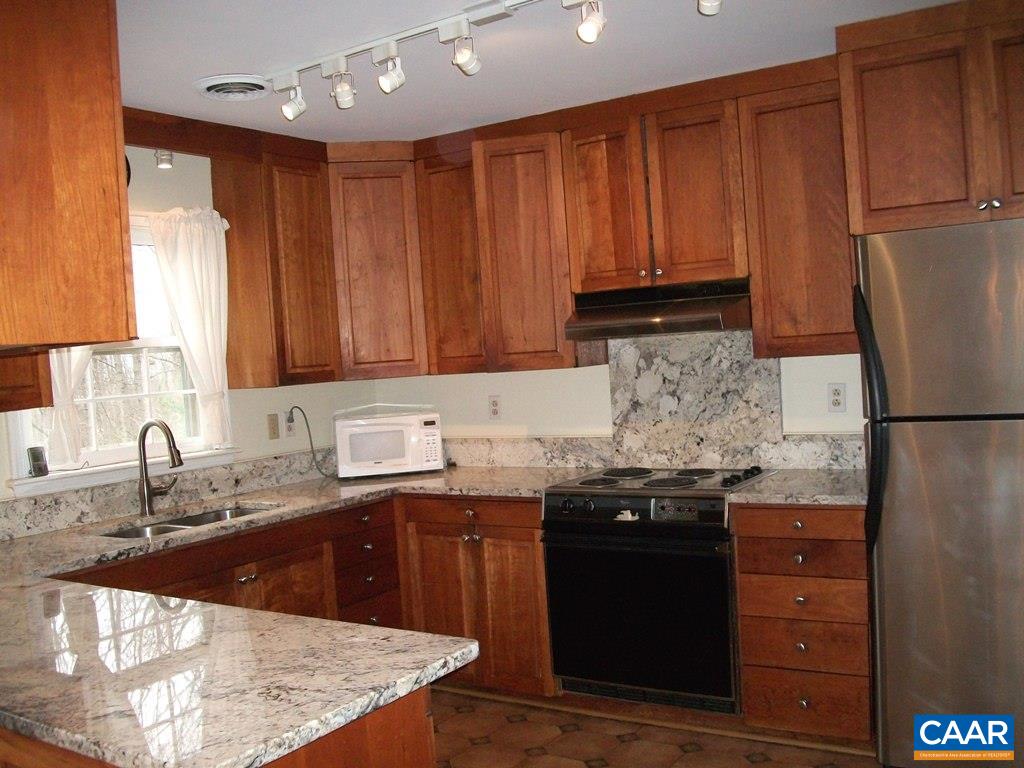 5584 Laurel Ridge Road Charlottesville, VA 22911 - Photo 7 of 28 a kitchen with granite countertop wooden cabinets and a sink