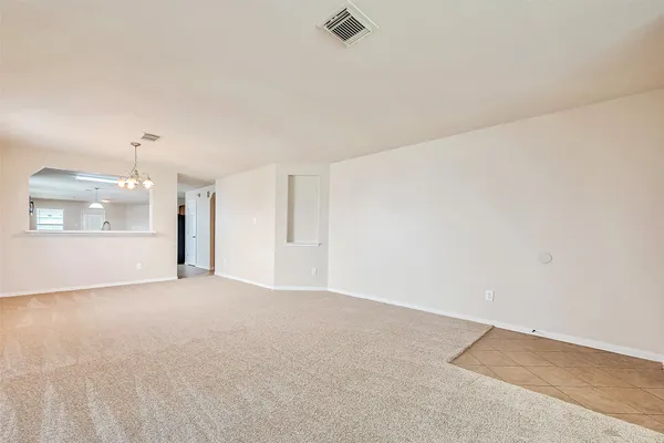 an empty room with a empty space and windows