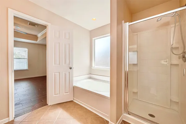 a bathroom with a tub and shower