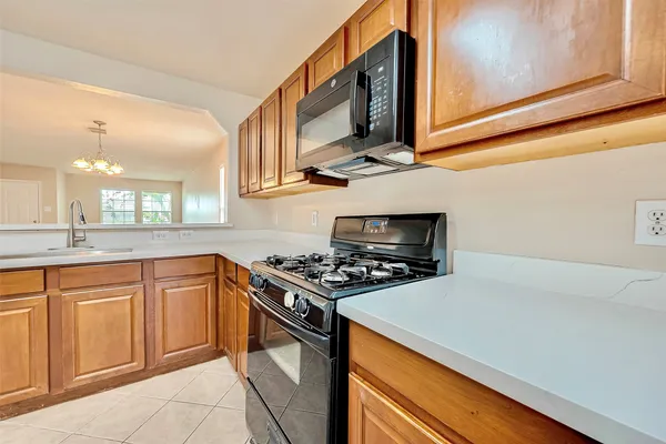 a kitchen with stainless steel appliances granite countertop a stove and a microwave