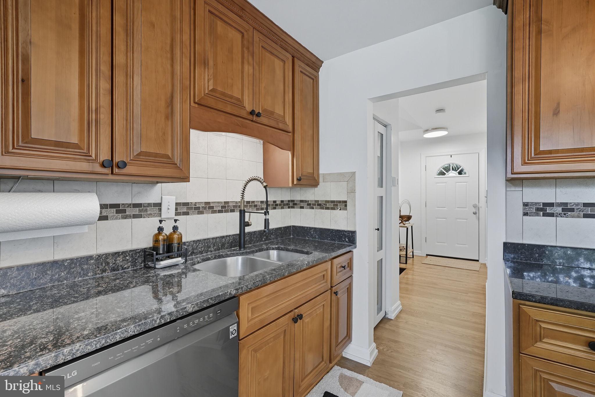2411 Lillian Drive Silver Spring, MD 20902 - Photo 14 of 48 a kitchen with granite countertop a sink and a stove