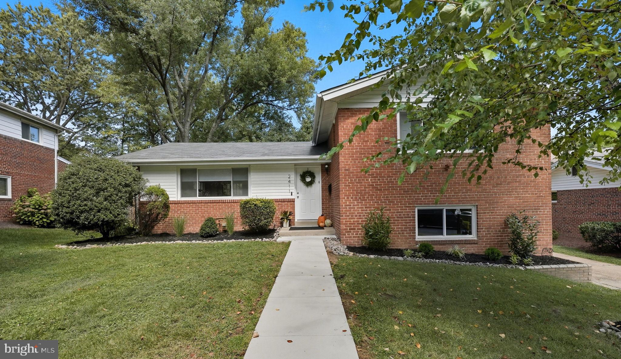 2411 Lillian Drive Silver Spring, MD 20902 - Photo 2 of 48 a front view of a house with a yard and porch