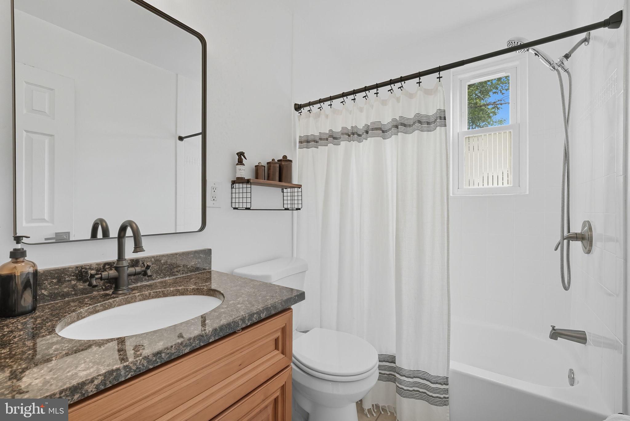 2411 Lillian Drive Silver Spring, MD 20902 - Photo 25 of 48 a bathroom with a granite countertop sink toilet and shower