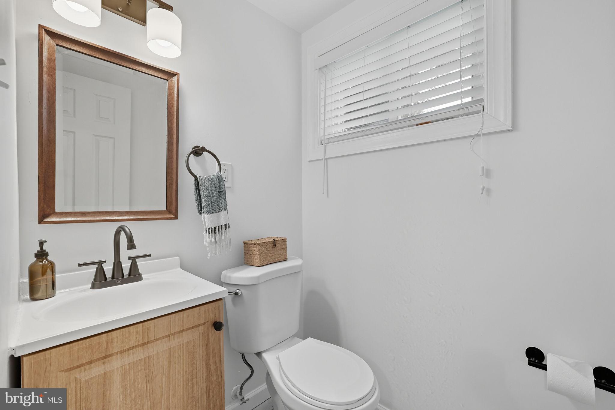 2411 Lillian Drive Silver Spring, MD 20902 - Photo 38 of 48 a bathroom with a toilet sink and mirror