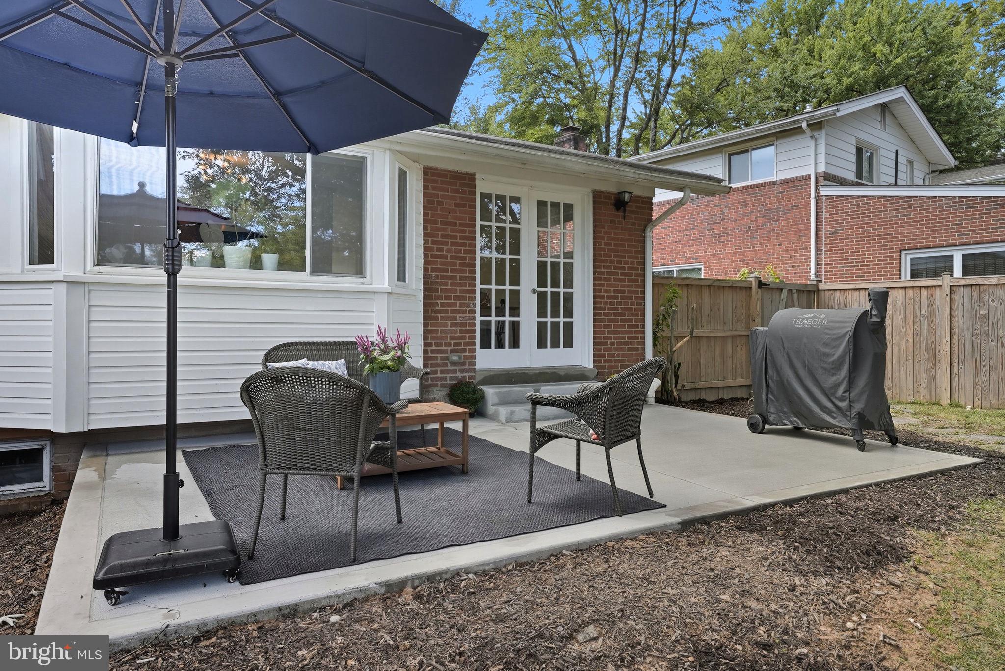 2411 Lillian Drive Silver Spring, MD 20902 - Photo 44 of 48 a view of a patio with table and chairs under an umbrella