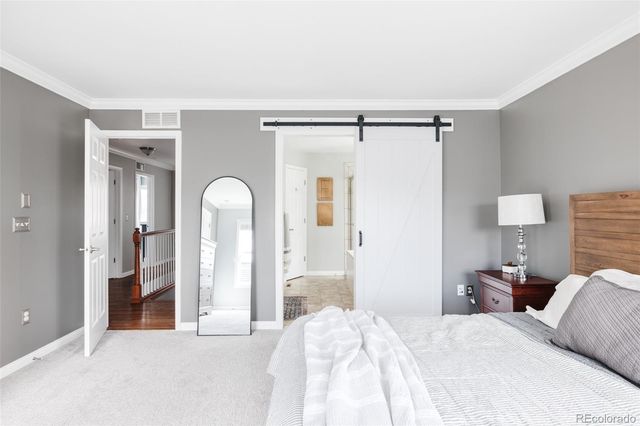 a bedroom with a bed and a lamp