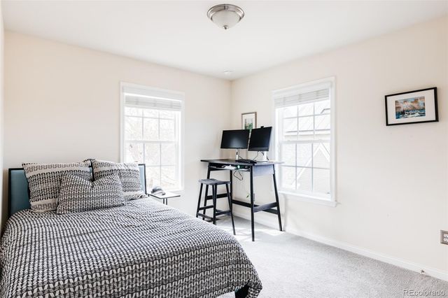 a bedroom with a bed and a tv on the dresser