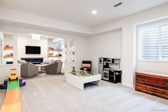 a living room with fireplace furniture and a flat screen tv