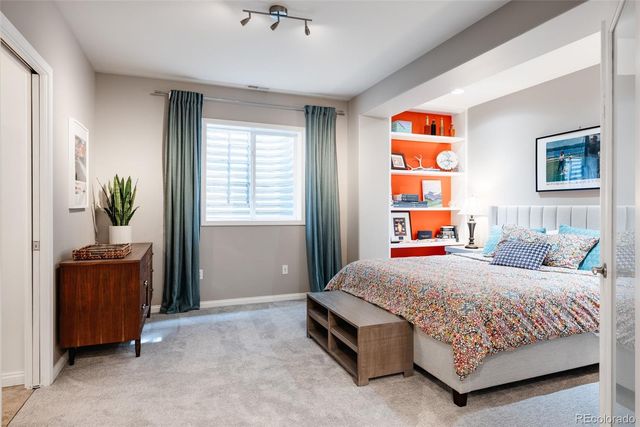 a bedroom with a bed and a book shelf