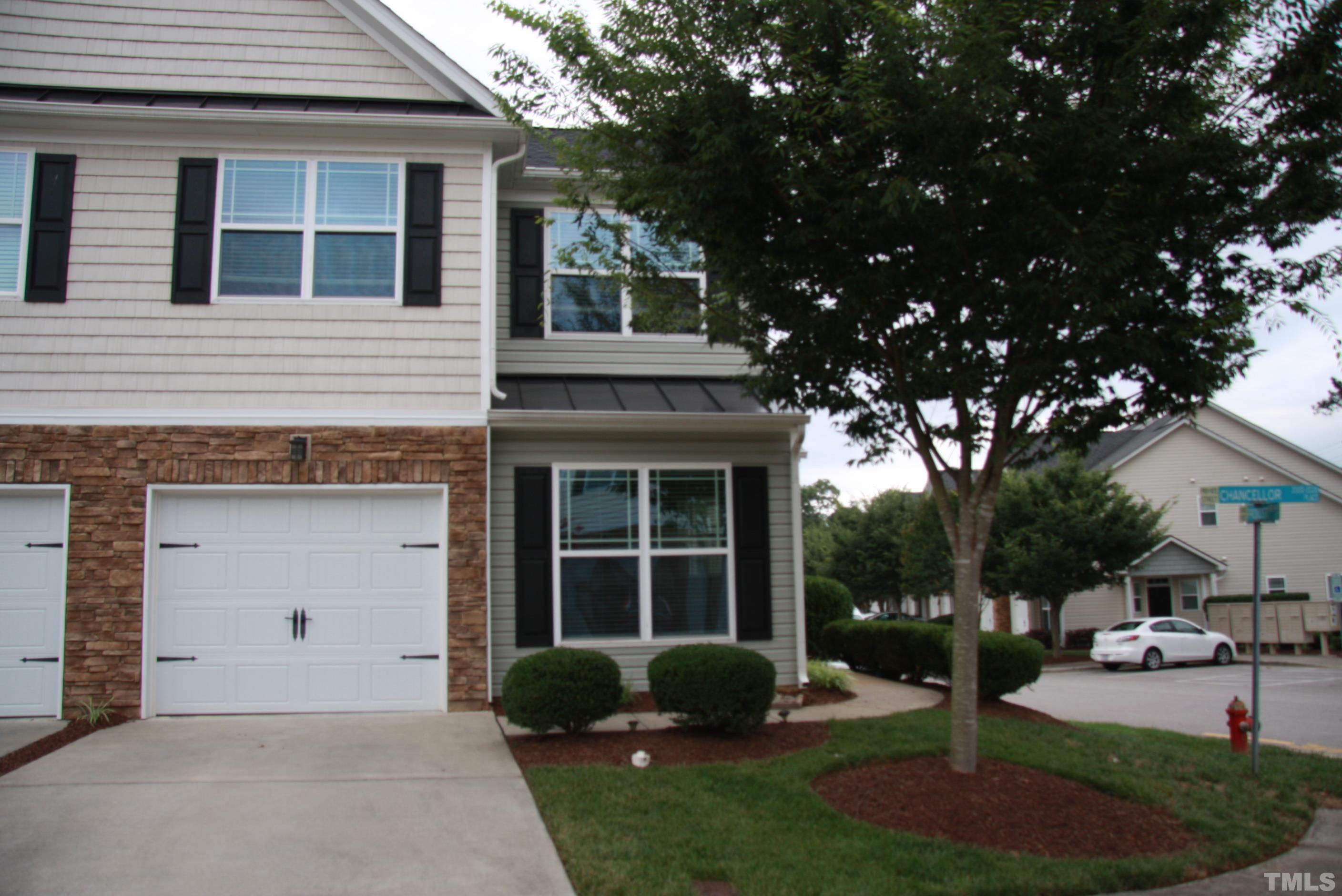2021 Chancellor Place Raleigh, NC 27603 - Photo 1 of 30 a front view of a house with garden and porch