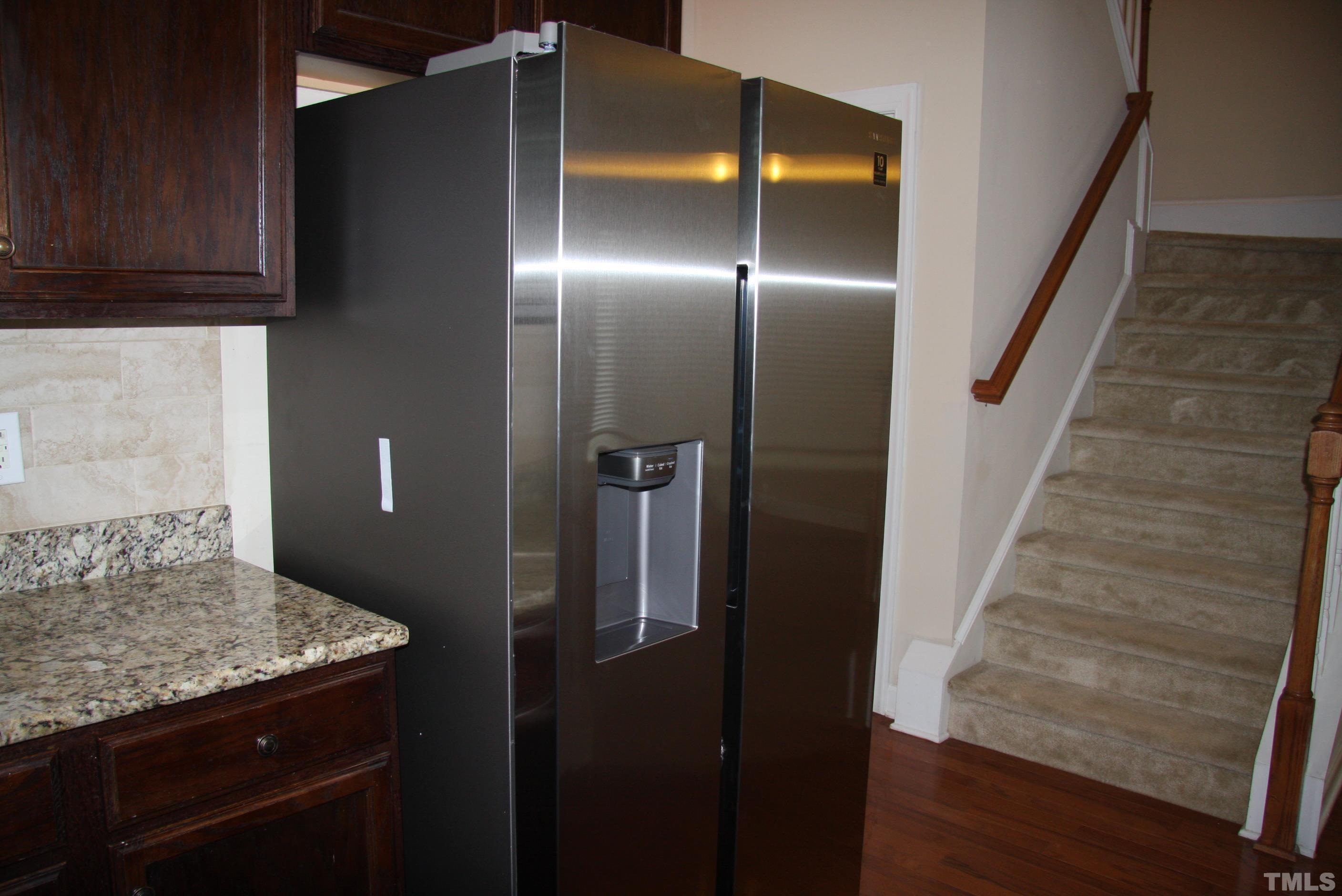 2021 Chancellor Place Raleigh, NC 27603 - Photo 12 of 30 a kitchen with a refrigerator and a stove