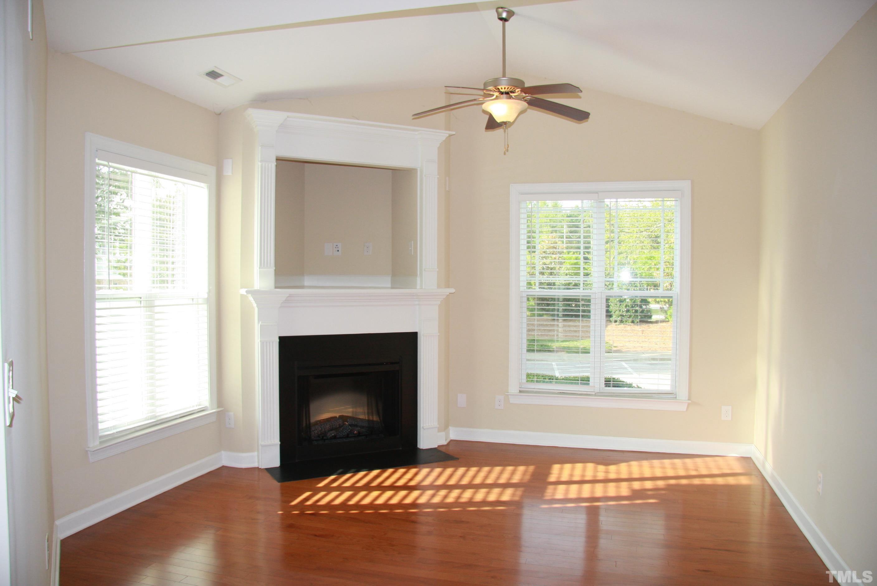 2021 Chancellor Place Raleigh, NC 27603 - Photo 13 of 30 a living room with a fireplace and a window