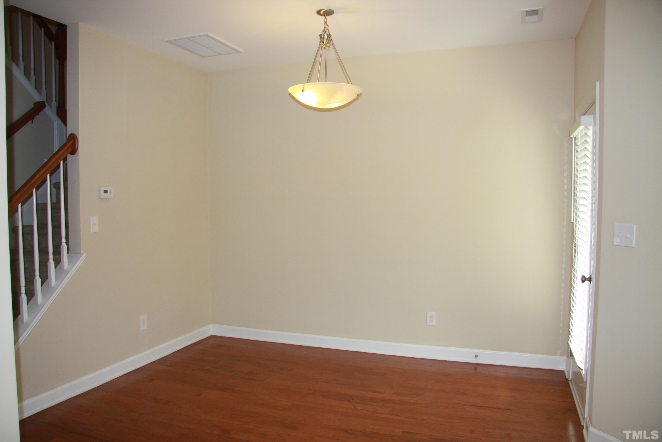 2021 Chancellor Place Raleigh, NC 27603 - Photo 14 of 30 an empty room with wooden floor and windows