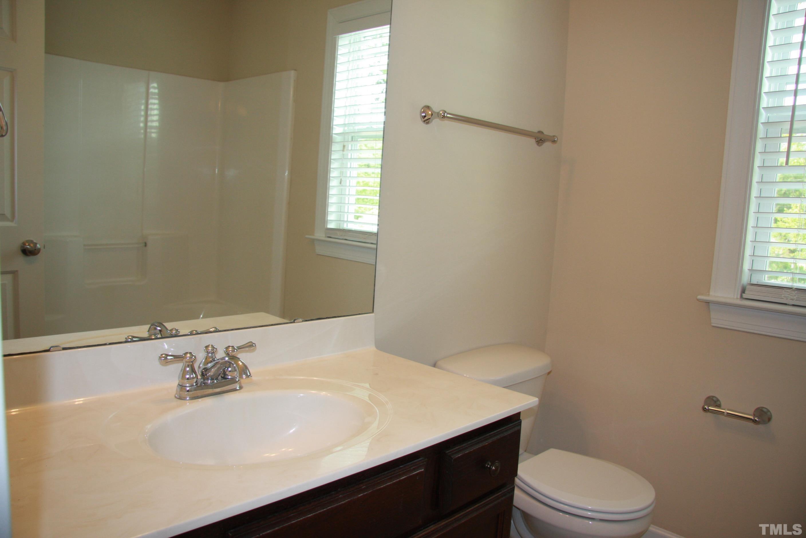 2021 Chancellor Place Raleigh, NC 27603 - Photo 23 of 30 a bathroom with a sink a toilet and window