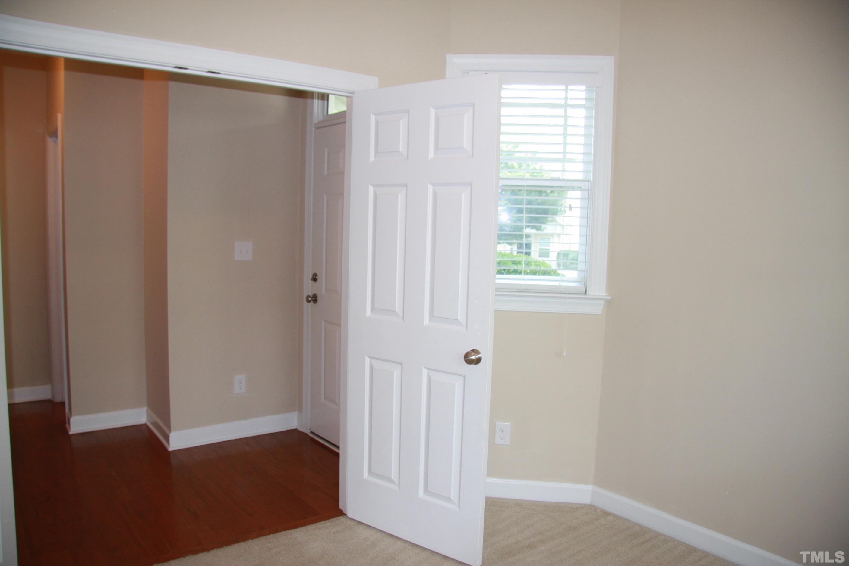 2021 Chancellor Place Raleigh, NC 27603 - Photo 4 of 30 a view of an empty room with wooden floor and a window