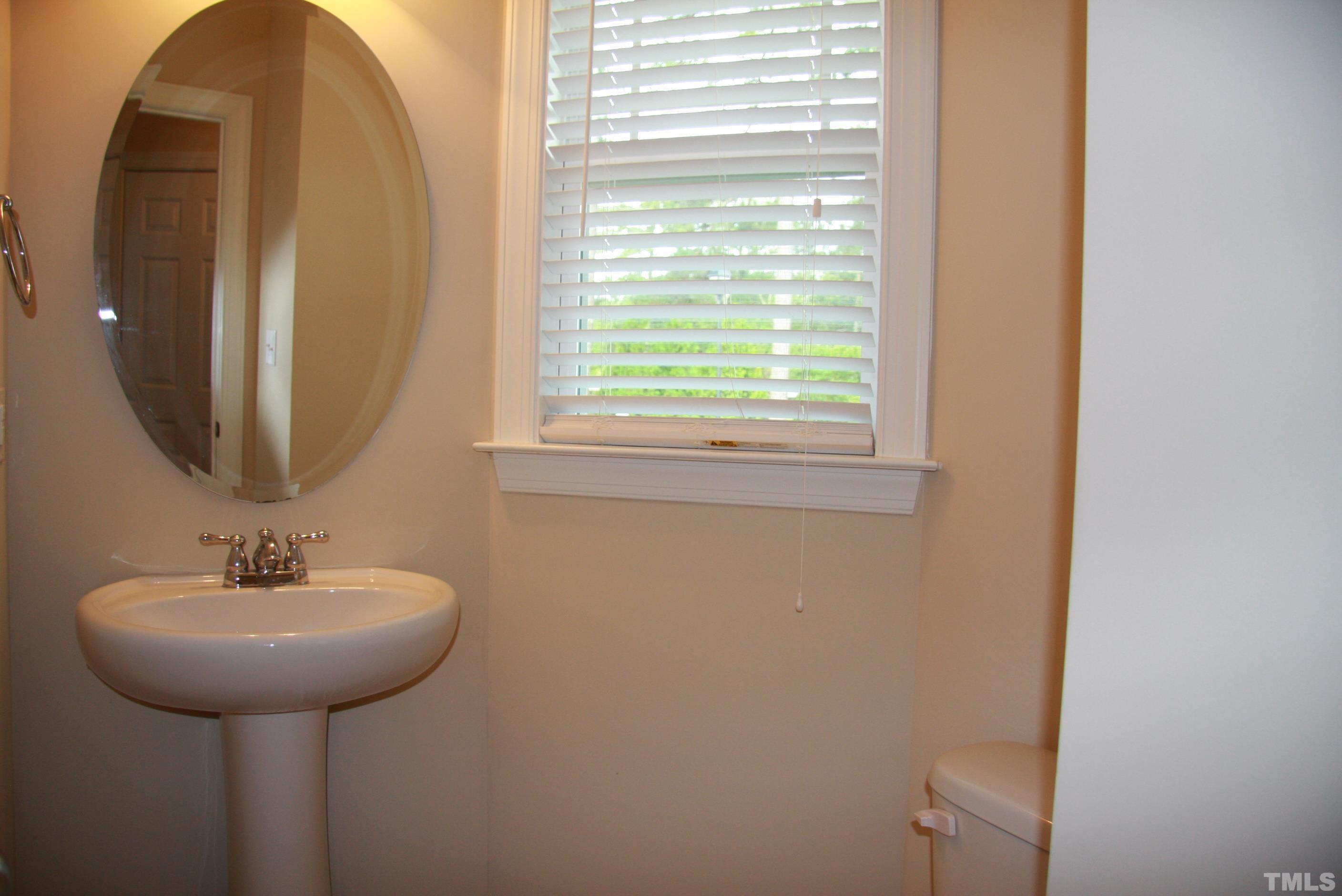 2021 Chancellor Place Raleigh, NC 27603 - Photo 7 of 30 a bathroom with a sink and a mirror