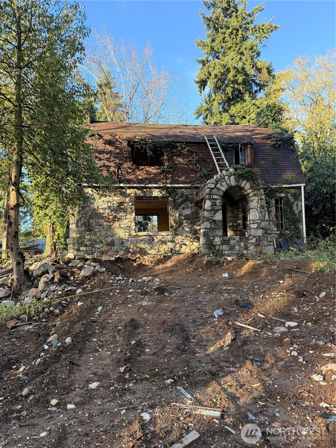 a view of house with car parked beside of it