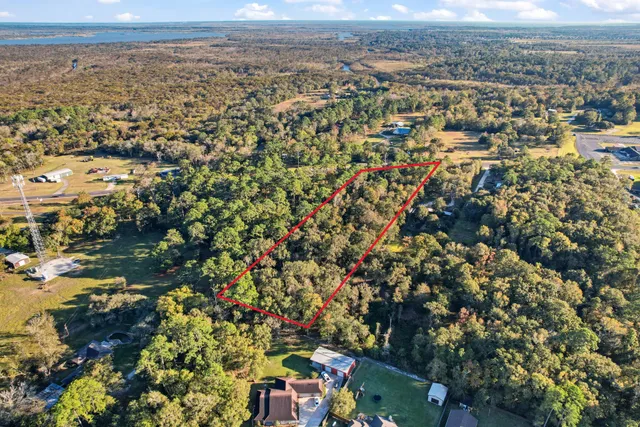 an aerial view of residential house with yard and mountain view in back
