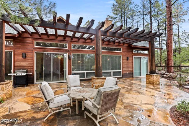 a view of a patio with chairs and floor to ceiling window