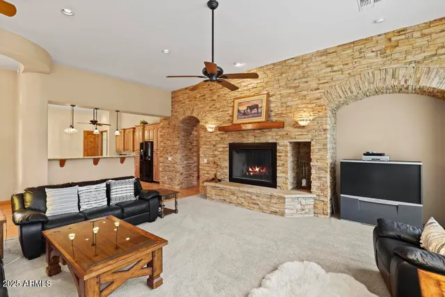 a view of a hallway with wooden floor and chandelier