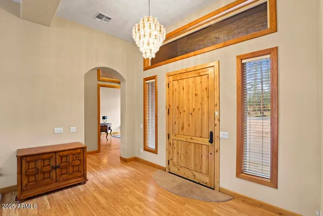 a living room with furniture large window and a table