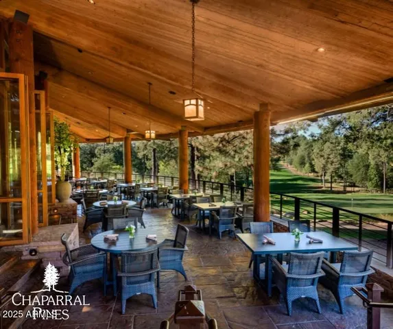 a view of a patio with dining table and chairs