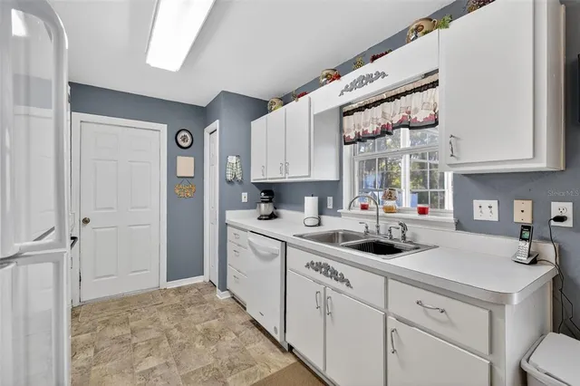 a kitchen with a sink cabinets and window